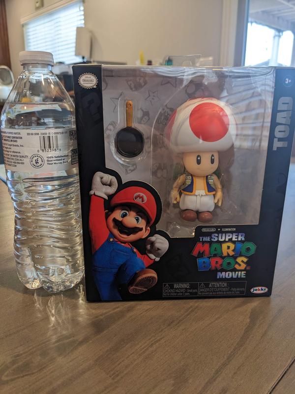 toad figure next to water bottle to compare size