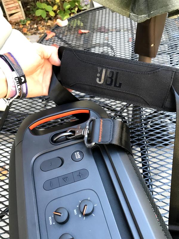 Top view of speaker with view of the shoulder strap.