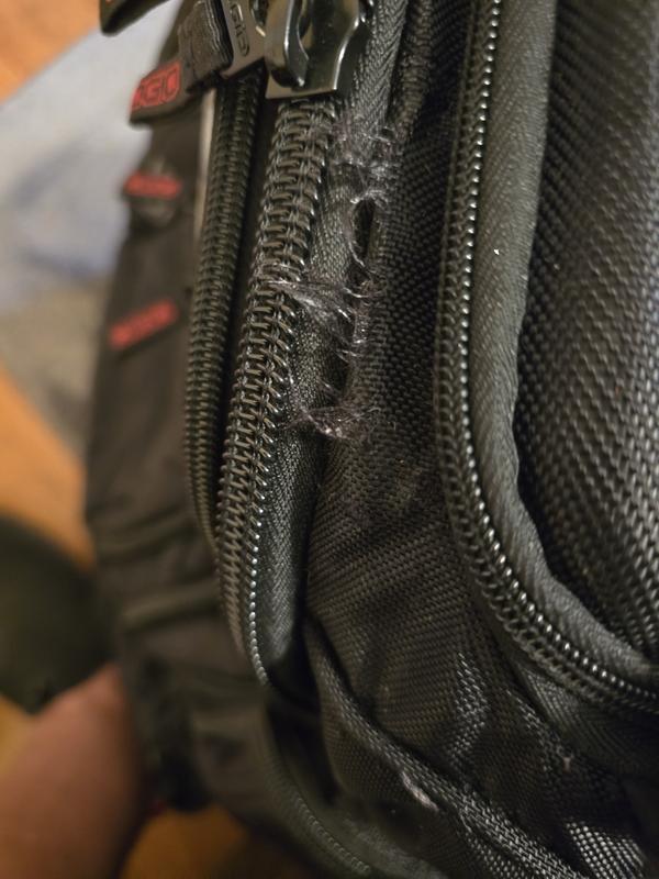 See the ripping along the main compartment zipper.