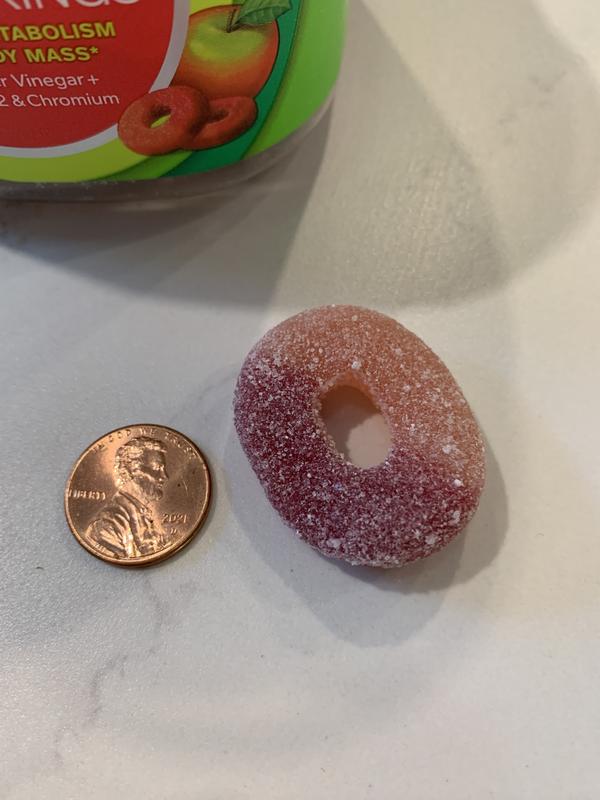 Olly Metabolism Gummy Rings size compared to a penny.