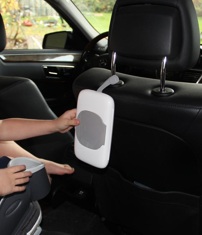 Little one using the wipes dispenser in the car on their own 1/3
