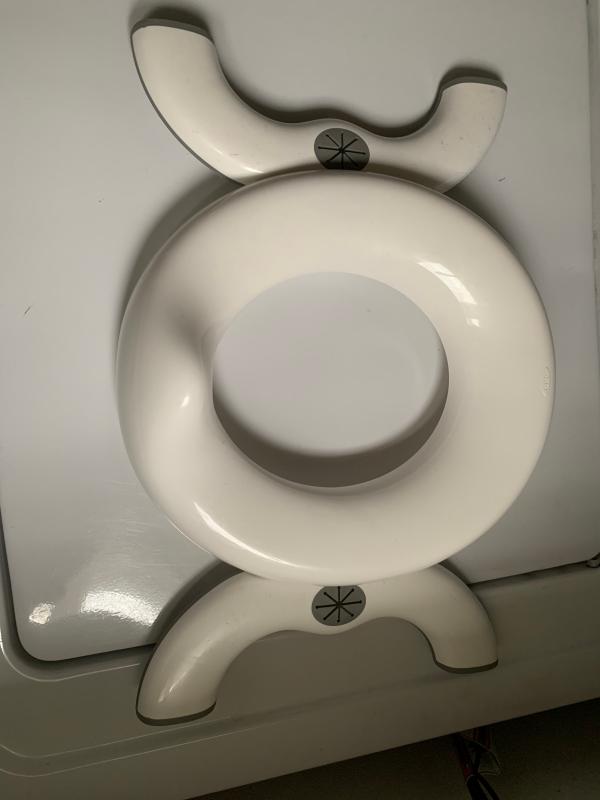 Chair in the position to place on toilet.