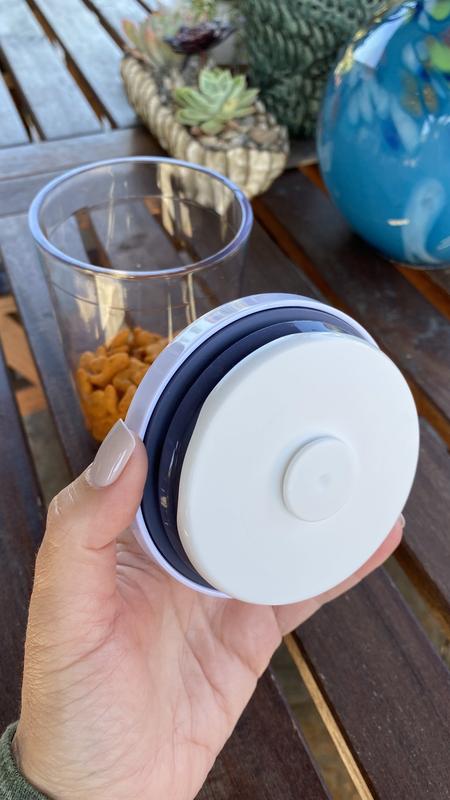 Oxo accessories (like a scoop) attach to underside of lid