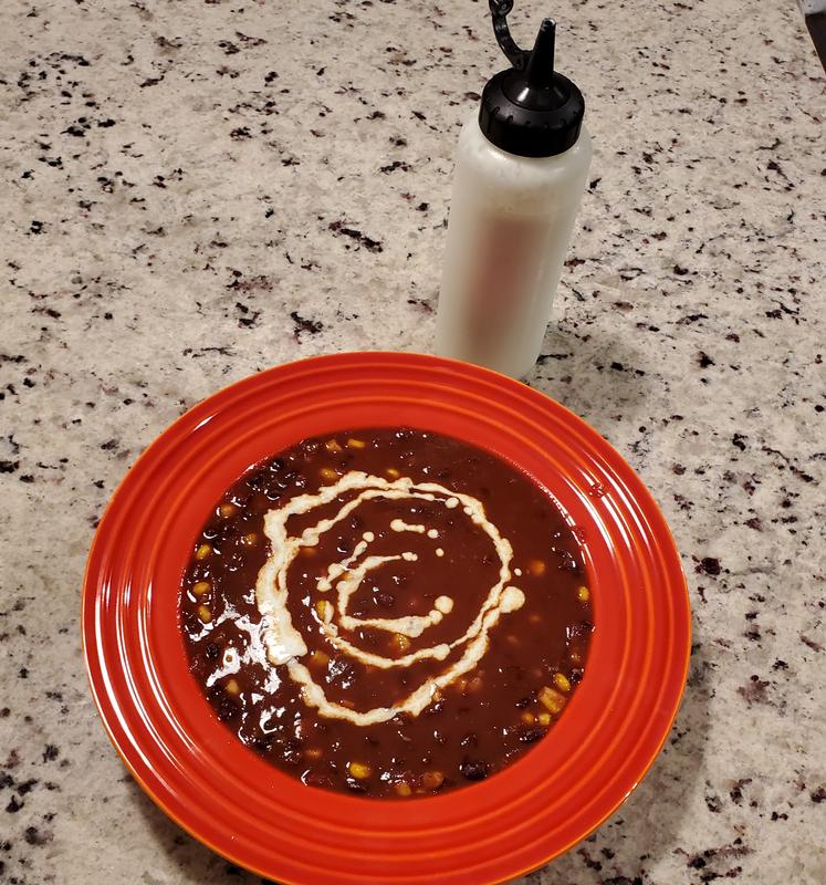 Herb and lime crema on black bean soup.