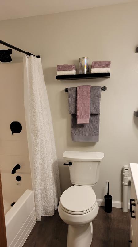 Towel bar above discount toilet paper holder