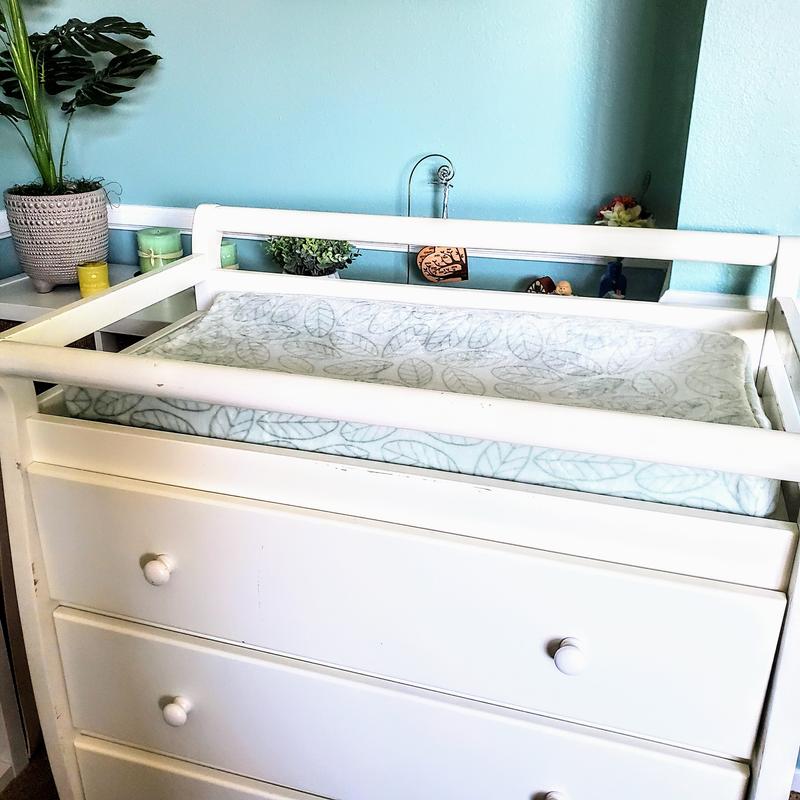 Changing table/dresser with the Jungle Friends changing pad cover in a crisp, clean, mint color.