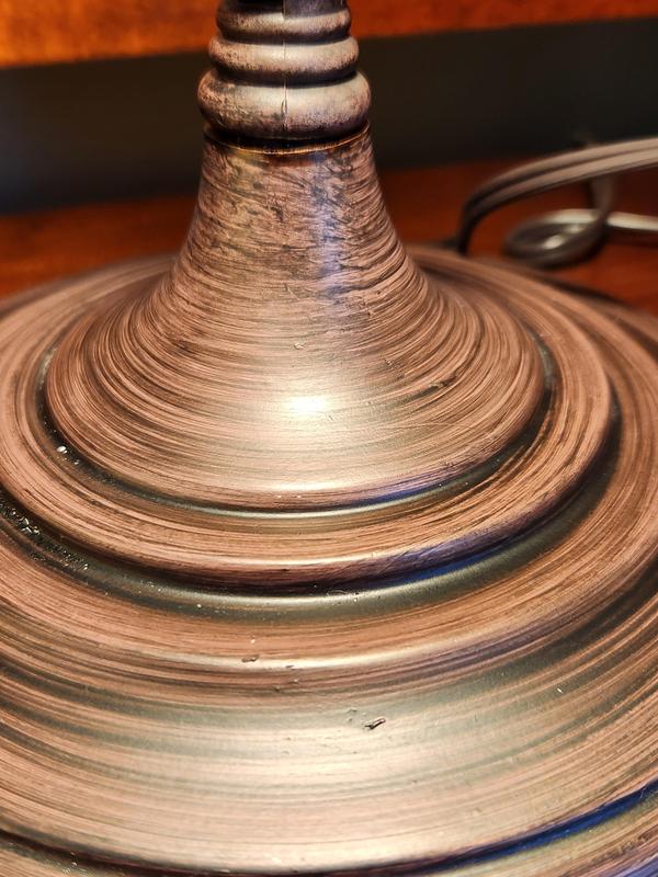 Bronze metal finish is actually painted with very obvious brush strokes