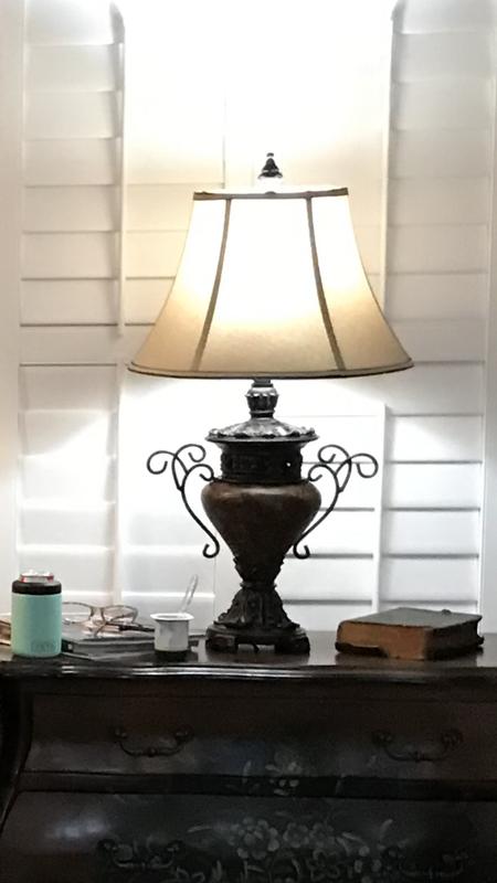 Large bronze urn lamps go well with dark furniture.