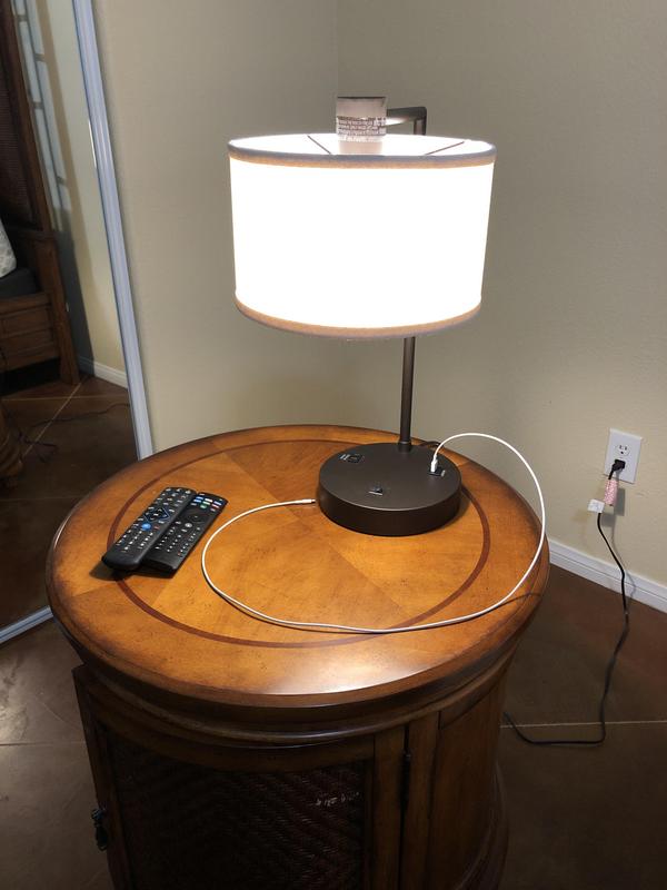 Lamp sitting on circular nightstand