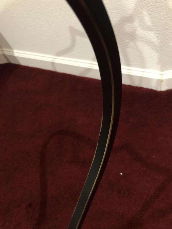 Gold distressing on every corner of black arms.