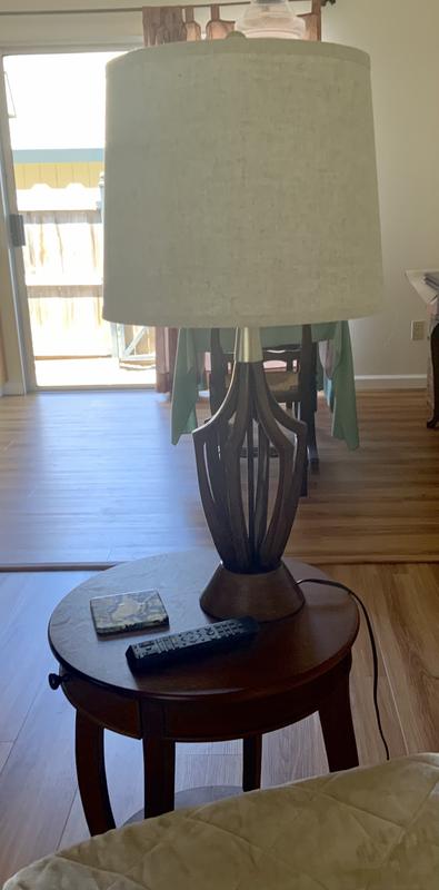 Lamp on table by chair