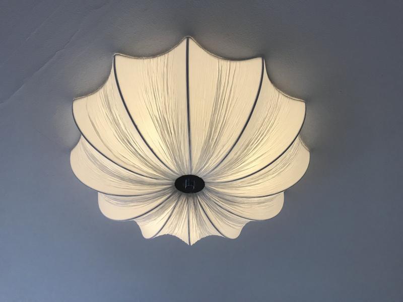 The lampshade’s ribs and fabric folds look dark gray when the light is off (the rest looks white)