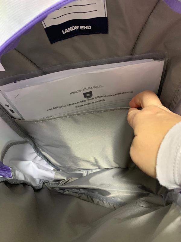 new backpack with flimsy inner lining, no extra side panel flap.