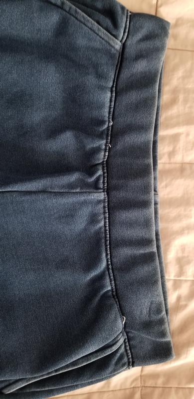 Loose threads around waistline.