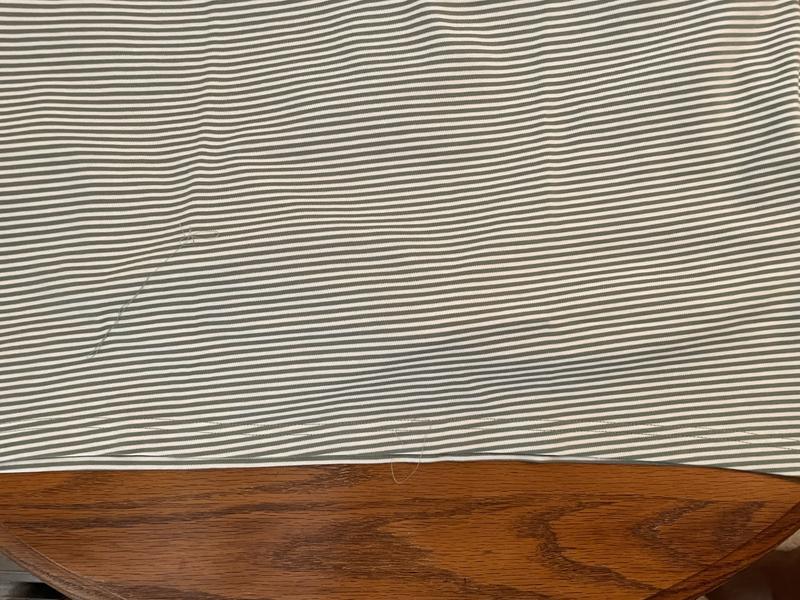 Bottom hem is cut at an uneven angle, and is not parallel with the stripes. Sloppy quality control.