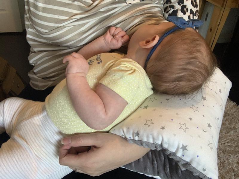 Arm pillow outlet for holding baby