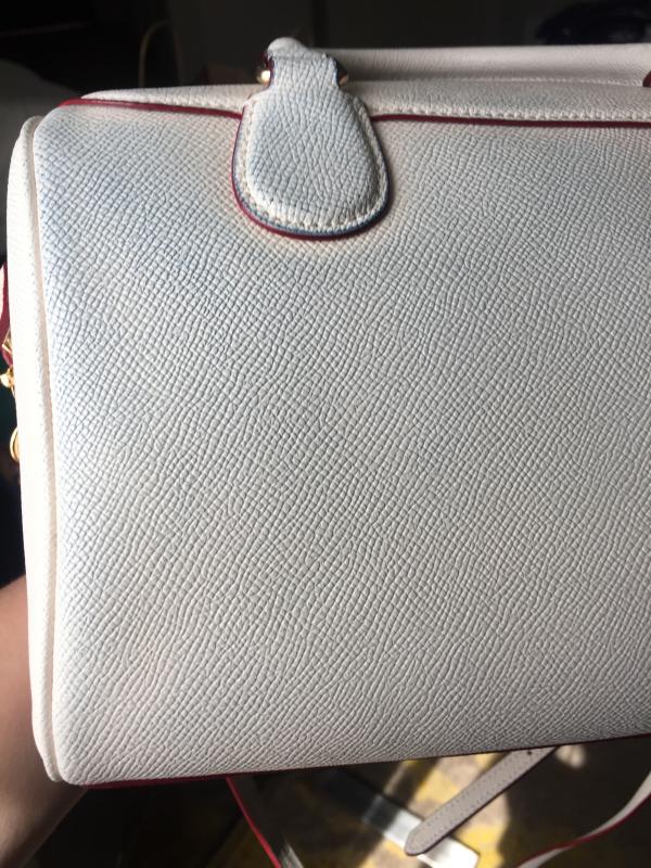 My brand new white leather handbag now stained blue