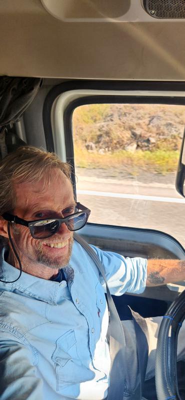 Levis light blue western style denim long sleeve shirt while driving semi truck.