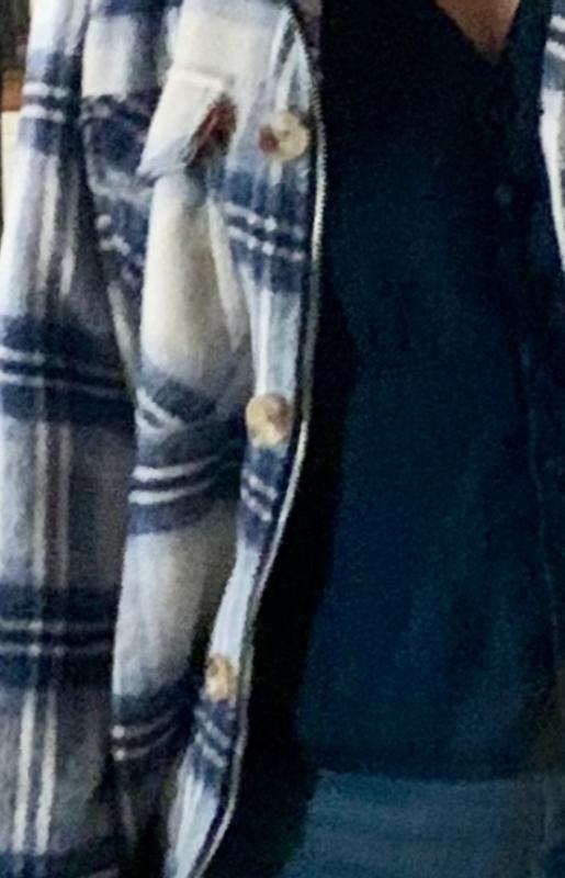 The blue plaid has both Zipper and button closure