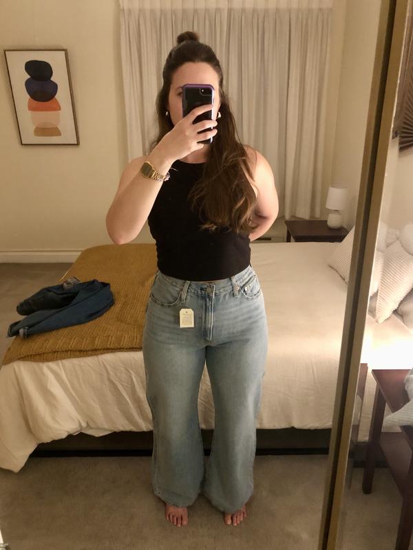 Front, holding waist band tight