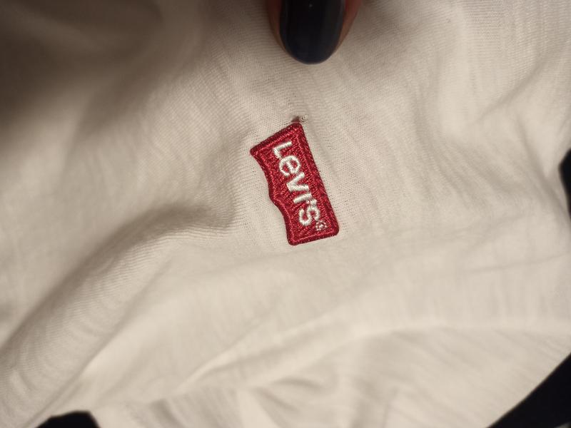 Small tear at logo