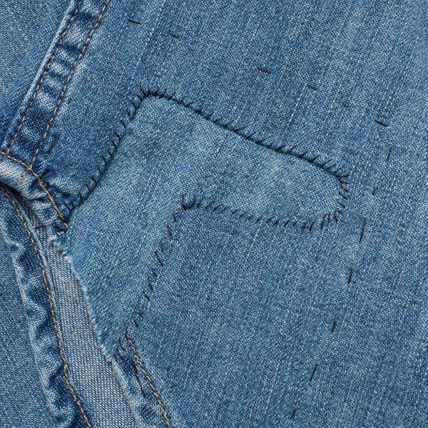 The repair patch added to the right hem for character