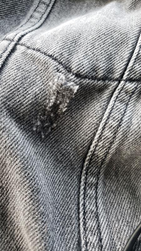 A repaired cut below the left breast pocket
