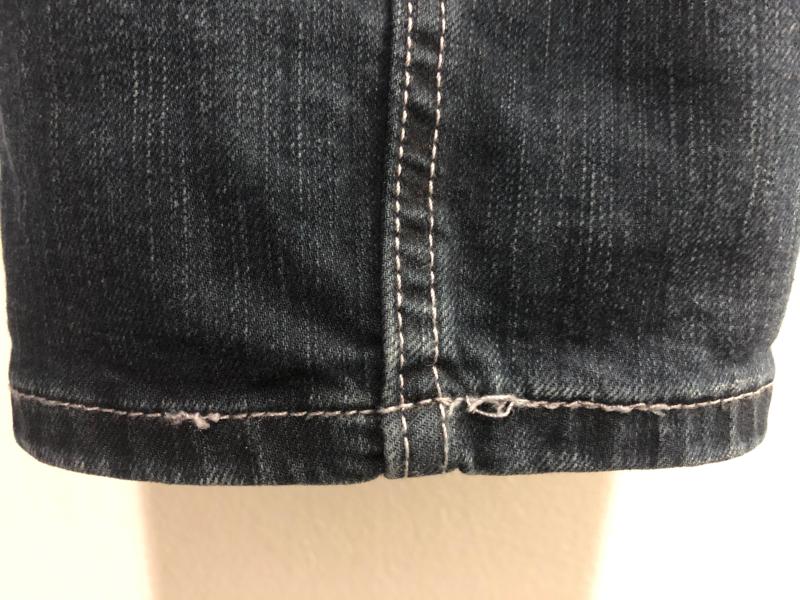 Loose threading at bottom hem