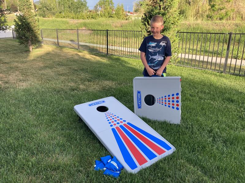 My son holding one corn hole