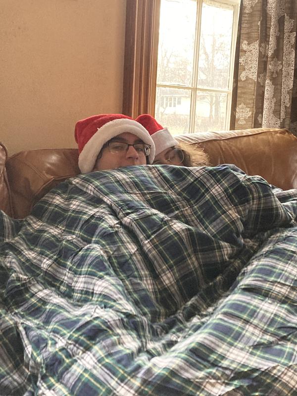Cuddling under their favorite Christmas present.