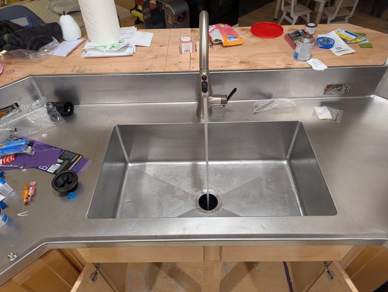 Placed in with stainless steel countertop and integrated sink.