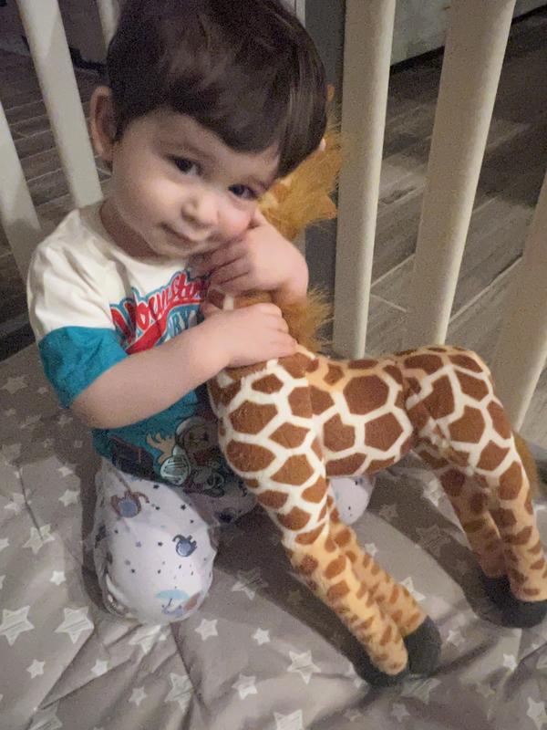 Sweet baby loving his new giraffe !