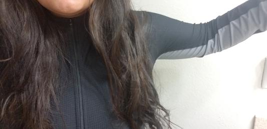 Zips up more than halfway up the neck and the gray accent runs down the arm.