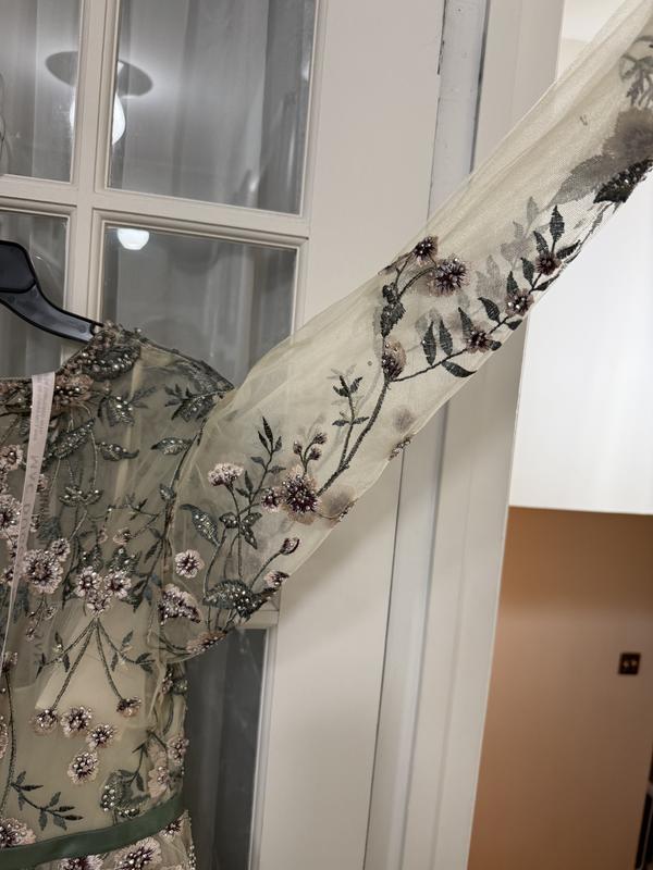 Appliqué intended to run down top of arm are seen underneath.