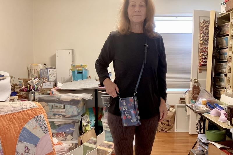 Me in my craft space wearing the bag