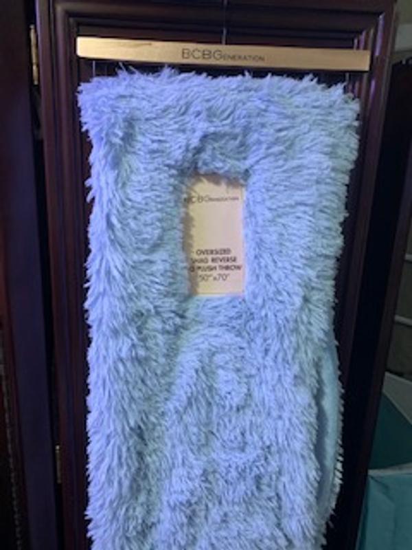 Blanket comes on a BCBGeneration hanger.