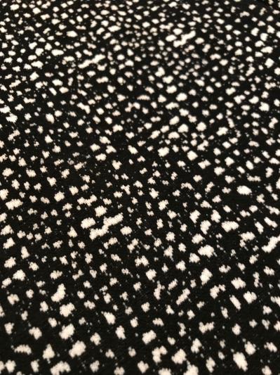 Not an actual itchy tweed, but feels more like a knit with stretch