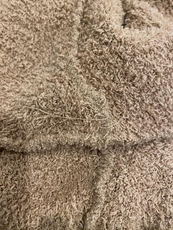 Loose threads throughout the interior of the garment, although everything has held together through initial washes.