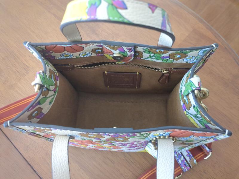 One interior zip pocket. Fits my card case and a compact