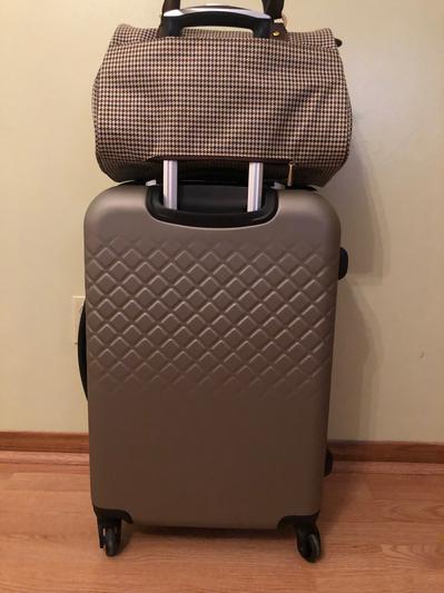 Slides over the suitcase’s handle -very nice feature