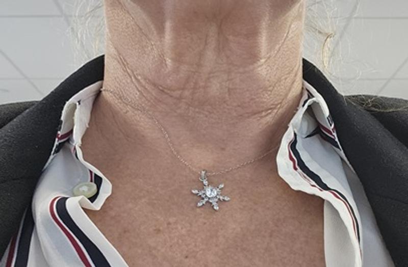 It almost looks like it's glued to my decolletage and not on a chain