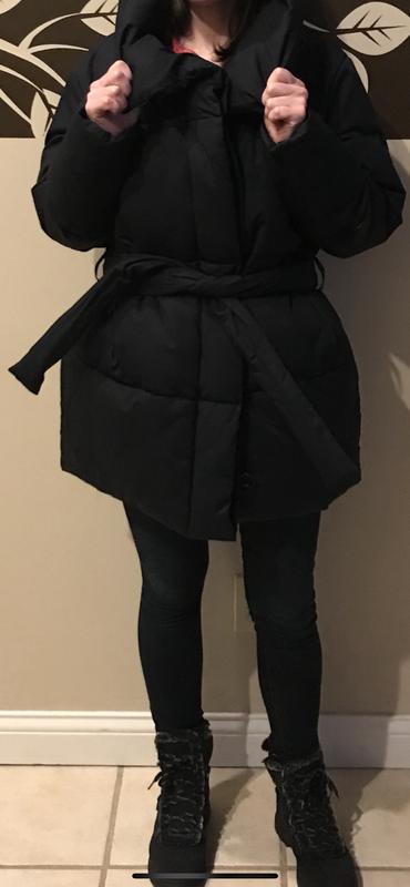 Coat with belt tied