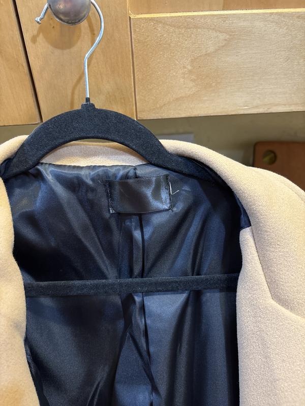 Poorly sewn in blank label with the original gone