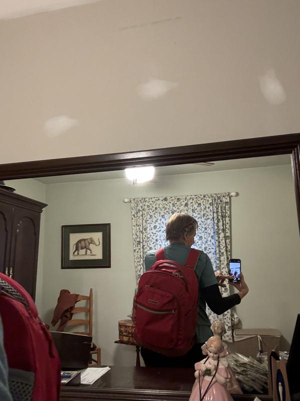 Inside and outside of backpack as well as one being worn by myself. One show excellent length of extended handle.