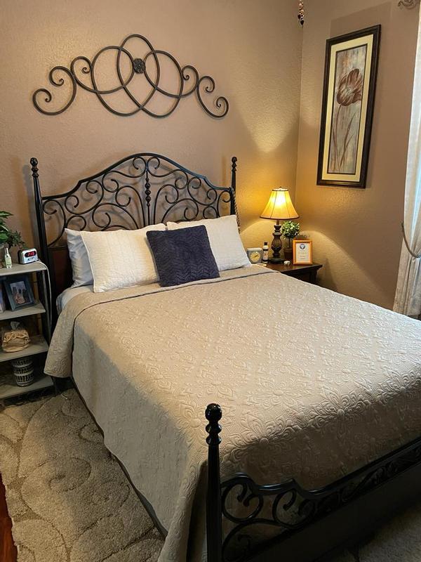 King size quilt on queen size bed.  Can't use the king size pillow shams though.