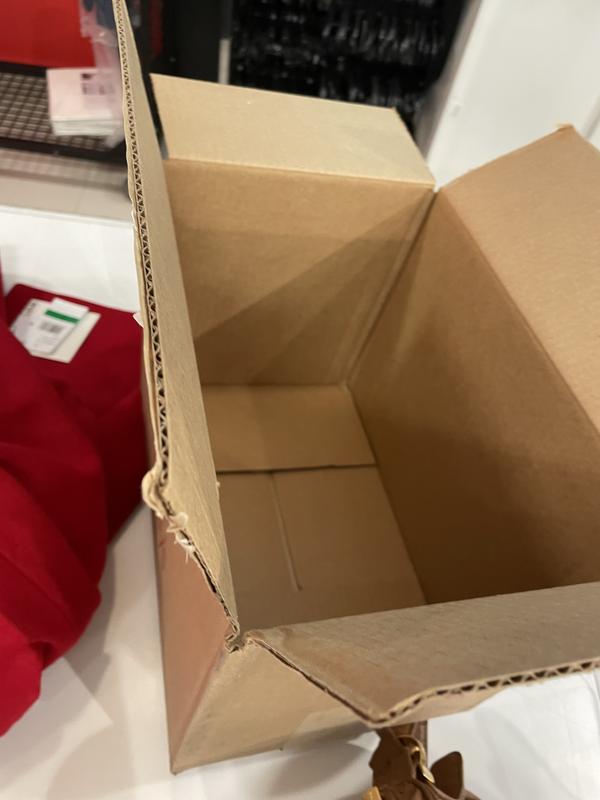 Coat rolled up and stuffed in a small box