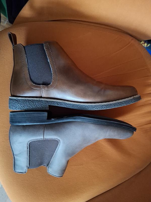Kids boot on top the lighter brown, mens style boot on bottom, darker