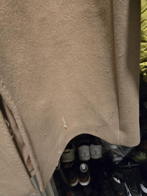 Notice the loose threads and stitching