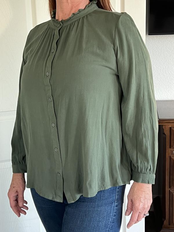 The shirt is very baggy but also short. It falls just barely below the waist on me.