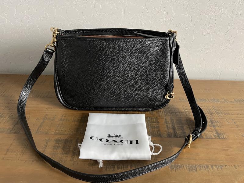 Long shoulder strap and dust bag.